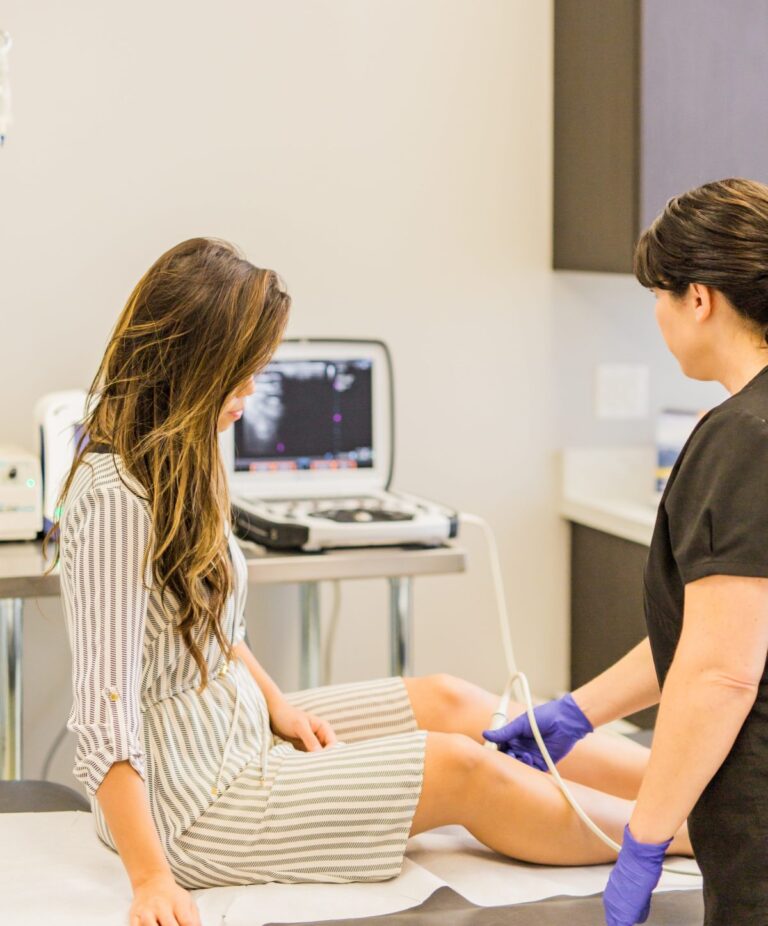 A woman receiving a doppler venous ultrasound