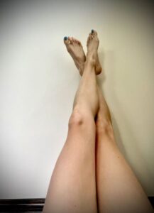woman putting legs up against the wall
