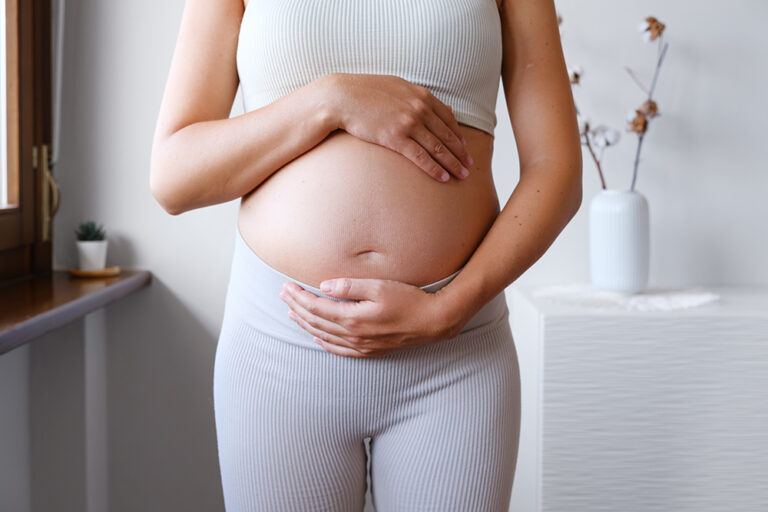 Pregnant woman holding belly