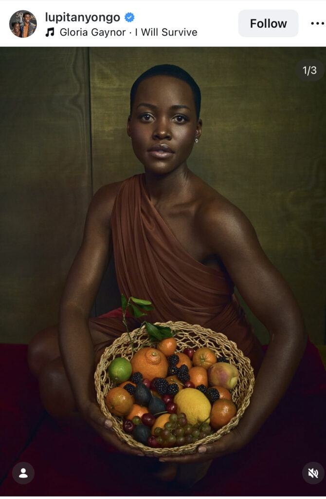 An image of Lupita Nyong'o holding a bowl of fruit