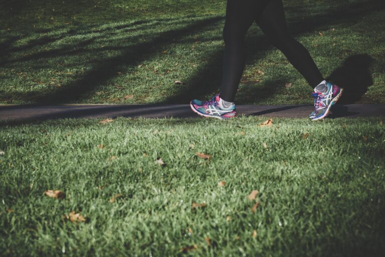 Close up of womans legs walking in a park
