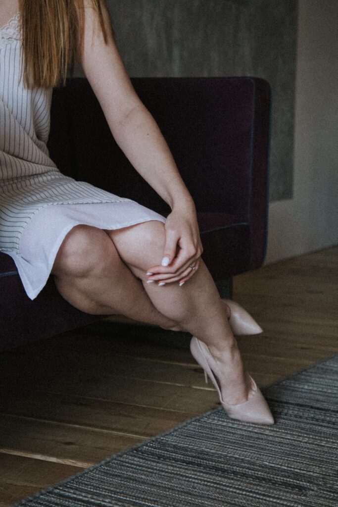 woman holding leg beneath the knee
