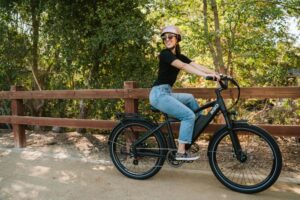 woman riding bike with helmet and sunglasses
